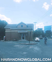Image of a stand alone dark corner store with clear blue sky in Grand Cayman