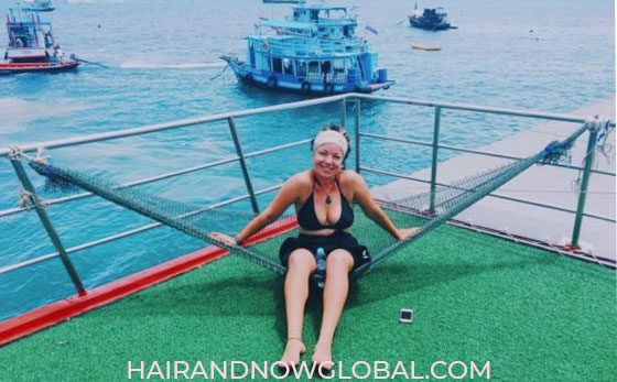 Female with alopecia sitting on hammock aboard PADI dive boat in Thailand