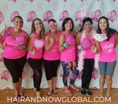 Group-of-females-dressed-in-pink-exercise-wear-for-pink-Pilates